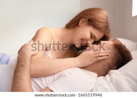 Happy young couple in bedroom
