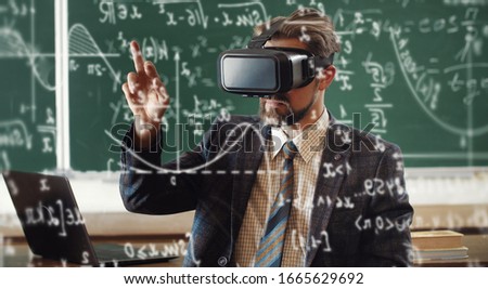 Portrait of bearded teacher in formal attire wearing virtual reality headset and using hologram screen