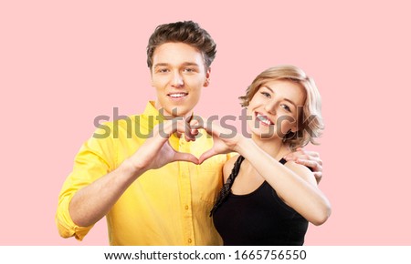 Lovely, romantic and cute couple making heart from hands