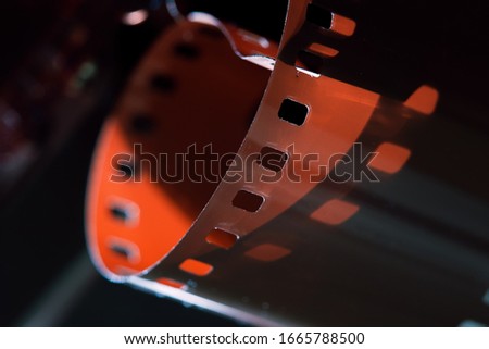 Photographic film close-up. Beautiful lighting. Shadows and relief of the film. Film Festival. The concept of cinematography and photo art.
