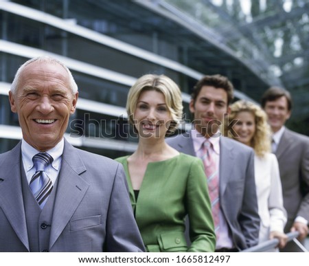Businesspeople standing in a row outdoors