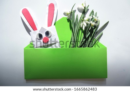 Handmade Easter greeting card with rabbit and snowdrops