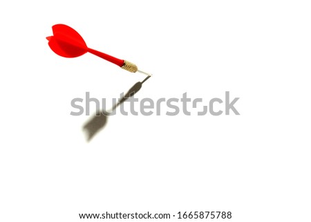 red dart sticking out of white space with shadow on a white background Royalty-Free Stock Photo #1665875788