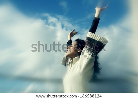 Beautiful Young Woman over blue Sky