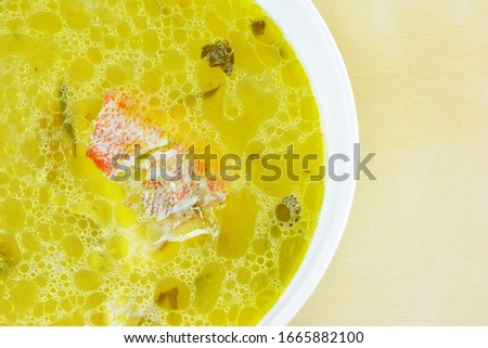 Fishing soup with red fish in bowl