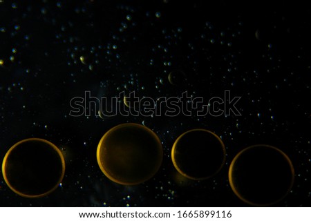 Water and Psychedelic oil abstract in gold and brown with a universe galaxy effect