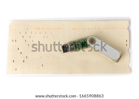 the history of computer data storage, vintage 80 column computer punch card and a modern USB memory key