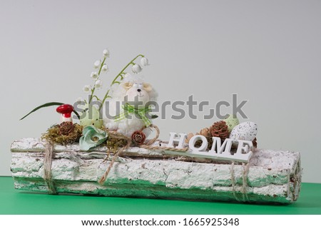 Easter holiday background with flowers and eggs and cute little sheep