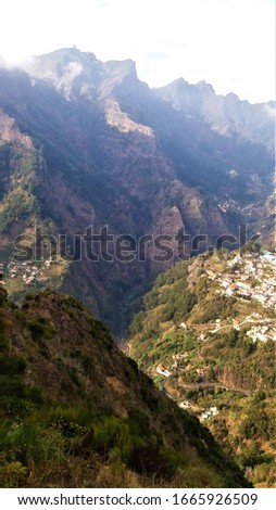 Deep valley and huge tall mountains in Madeira, Portugal. Cruise ship travels. 