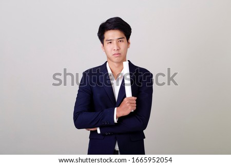 Portrait asian businessman hold document roll on white wall background, Financial investment and personal insurance concepts