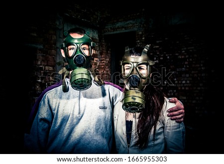 environmental disaster couple in love wearing gas mask