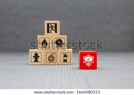 Wooden toy blocks with protect icon for fire safety protection and insurance concepts.