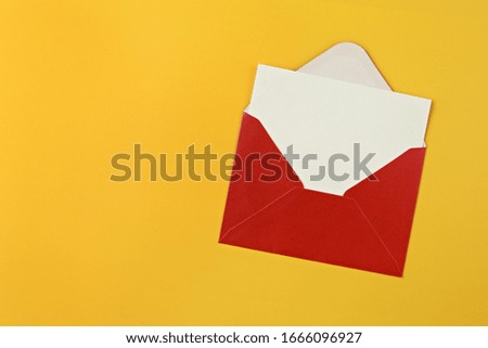 Red envelope with blank card on yellow background.