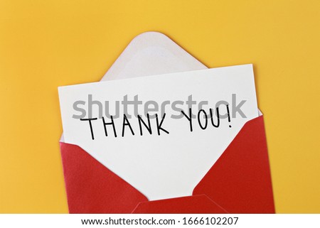 Red envelope and white card with text "Thank You!" on yellow background
