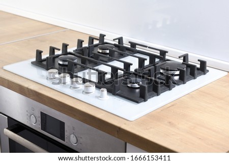 Burners on a white glass gas cooker in the kitchen. View from above. Royalty-Free Stock Photo #1666153411