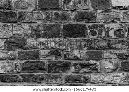 Old historic protected wall. Shabby bumpy style of front facade citadel. Hard trim carved plates on palace courtyard. Black white chipped marble on mansion loft backyard. Grungy coarse barrier for 3d