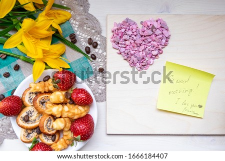 strawberry, cookie hearts with a Cup of black coffee beans, with yellow flowers and a note Good morning happy Valentine's day mother woman Easter day with love along with a place for text