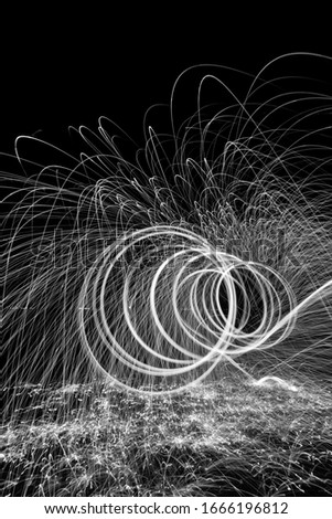 Long exposure image of painting with light. A simple photographic technique that gives amazing results. Sparkles of fire crated thanks to using the steel wool. 