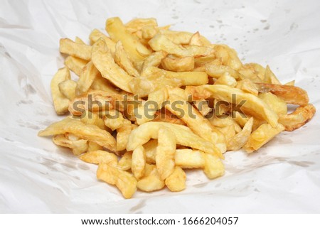 Deep fried potato chips from an English Fish and Chips shop Royalty-Free Stock Photo #1666204057