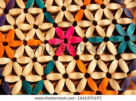multicolor floral pattern with wooden petals illuminated by sunlight