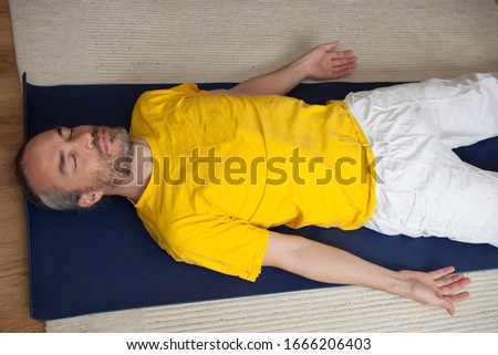 A man practicing Yoga at home Royalty-Free Stock Photo #1666206403