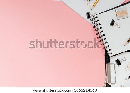 Mockup planner flat lay, top horizontal view pink background. Notepad and notebooks with stationary. Golden, white, pink and black c