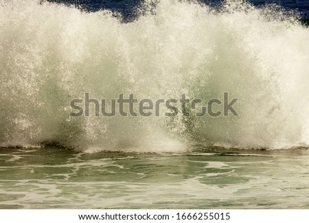 spray and white foam after a powerful wave
