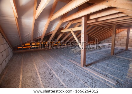 Ecowool insulation is poured in the attic. Eco-freandly clean Royalty-Free Stock Photo #1666264312