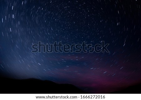 photography of long-exposure star forming a circumpolar
