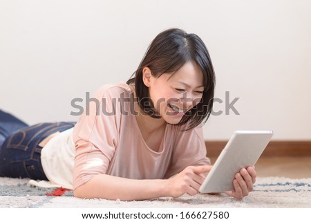 Young Asian woman using tablet computer