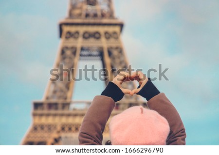 Child girl on a background of the Eiffel Tower in Paris. Selective focus. nature.