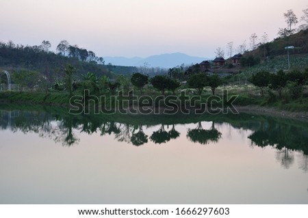 Landscape foreground is the marshes,middle ground is mountains and background the sky sunset
