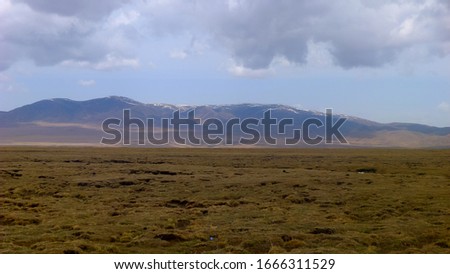 Beautiful Steppe Scenery and Snowy Mountains in the Distance. Gonghe County, Hainan Tibetan Autonomous Prefecture, Qinghai, CHINA