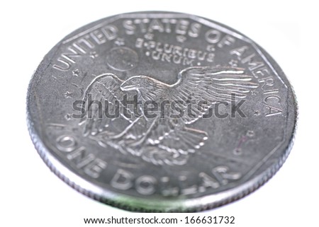 Close up shot of a silver dollar coin showing a bold eagle isolated on white