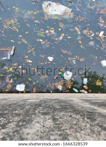 A lot of garbage floating on the water surface