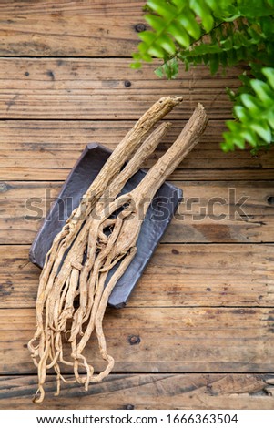 Codonopsis pilosula on wooden background.Chinese medicinal materials