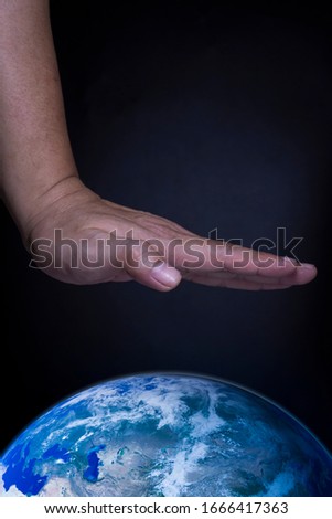 The hands of an Asian man protecting the world