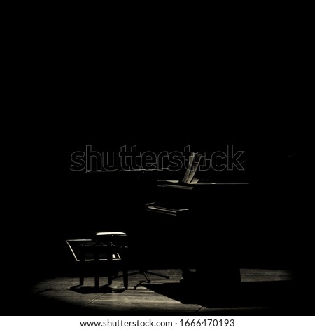 Grand piano in a glimmer of light