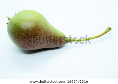 Green ripe beautiful pear located on a white background