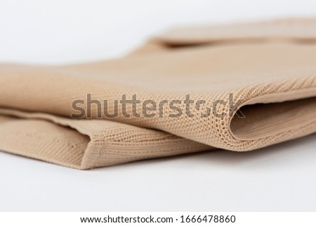 Close up of flat knit Graduated Compression Garments for leg lymphedema, edema and lipedema - powerful compression stocking for greater edema containment, isolated on white