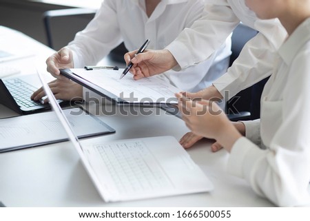 Business people reviewing paperwork in meeting Royalty-Free Stock Photo #1666500055