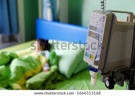 Vital sign monitor with background of blurry baby patient on bed in hospital