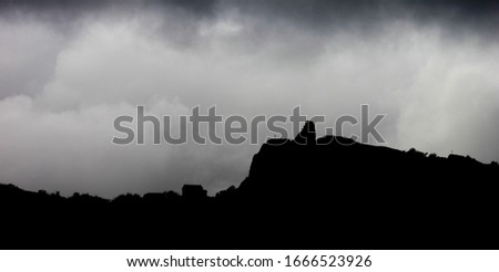 old tower with scary fog and mountains