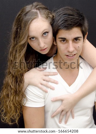 Young couple in love on black background
