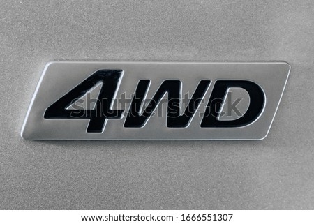 Close-up of four wheel drive sign on a car
