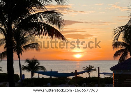 Grace Bay, Turks & Caicos Islands / British Overseas Territory - February 21, 2020: Dramatic sunsets are a regular feature on the long sandy beaches of Grace Bay near Providenciales in Turks & Caicos. Royalty-Free Stock Photo #1666579963