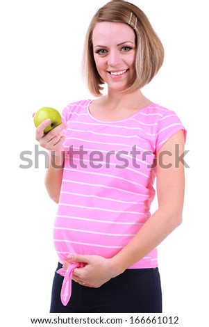 Young pregnant woman holding green apple isolated on white