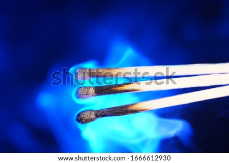 Lit matches and blown out in the studio photographed with colorful foils before the flashes                            