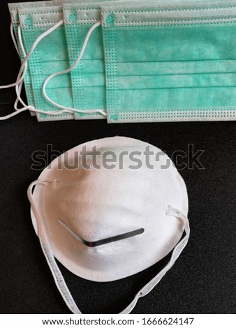 medical face masks for protection against corona viruses on a black background,photographed from above close-up