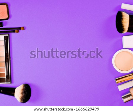 Cosmetics on a purple background. Top view. Text space.